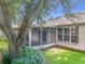 Back exterior view of screened in porch and shade tree at 1131 Turtle Lake Ct, Ocoee, FL 34761
