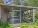 Outdoor screened-in back porch overlooking well-maintained landscaping and backyard with tree shade at 1131 Turtle Lake Ct, Ocoee, FL 34761