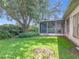 Backyard and screened-in back porch surrounded by mature shade trees at 1131 Turtle Lake Ct, Ocoee, FL 34761