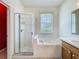 Bathroom featuring a glass-enclosed shower, soaking tub, and vanity at 1131 Turtle Lake Ct, Ocoee, FL 34761