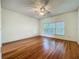 Bright bedroom with hardwood floors, a ceiling fan, and a large window at 1131 Turtle Lake Ct, Ocoee, FL 34761