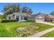Charming single Gathering home features a manicured lawn and attached two-car garage at 1131 Turtle Lake Ct, Ocoee, FL 34761