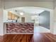 View of the eat-in kitchen and breakfast bar from living room with hardwood floors at 1131 Turtle Lake Ct, Ocoee, FL 34761