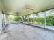Screened lanai featuring tile floors, dual ceiling fans, and views of the large backyard space and landscaping at 1131 Turtle Lake Ct, Ocoee, FL 34761