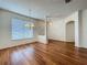 Open-concept living area with hardwood floors, bright windows and chandelier at 1131 Turtle Lake Ct, Ocoee, FL 34761