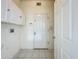 Mud room featuring white walls, a door to the exterior, and cabinetry for storage with tile floor at 1131 Turtle Lake Ct, Ocoee, FL 34761
