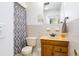 Cozy bathroom with a neutral color scheme, wood vanity, and shower-tub combo at 1135 Plato Ave, Orlando, FL 32809