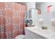 Bathroom featuring an patterned shower curtain, a white vanity, and decorative accents at 1135 Plato Ave, Orlando, FL 32809