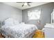 Bright bedroom featuring a ceiling fan, hardwood floors, and a floral bedspread at 1135 Plato Ave, Orlando, FL 32809
