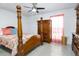 A cozy bedroom features wood furniture, hardwood floors, and natural light at 1135 Plato Ave, Orlando, FL 32809