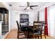 Dining area features a modern black dining set, stainless steel fridge and bright natural light at 1135 Plato Ave, Orlando, FL 32809