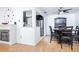 Cozy dining area featuring an adjacent kitchen, wood floors, and ample lighting at 1135 Plato Ave, Orlando, FL 32809