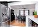 Dining room view featuring stainless steel refrigerator, black dining set, and hardwood flooring at 1135 Plato Ave, Orlando, FL 32809