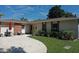 Charming single-story home with brick accents, landscaped yard, and inviting outdoor seating area at 1135 Plato Ave, Orlando, FL 32809