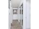 Bright hallway with white walls, mirrored closet doors, and modern art at 1135 Plato Ave, Orlando, FL 32809