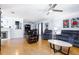 Open-concept living room showcasing wood floors, fireplace, and dining area with modern furnishings at 1135 Plato Ave, Orlando, FL 32809