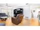 Living room with wood floors, comfortable recliners, and an entertainment center, perfect for relaxation at 1135 Plato Ave, Orlando, FL 32809