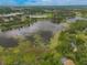 Aerial view showcases a community with multiple lakes, lush greenery, and scenic landscapes at 120 E Greentree Ln, Lake Mary, FL 32746