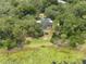 Breathtaking aerial view of backyard featuring a sparkling pool and outdoor fireplace embraced by lush greenery at 120 E Greentree Ln, Lake Mary, FL 32746