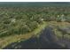Scenic aerial view of a lakefront home nestled among lush greenery and mature trees at 120 E Greentree Ln, Lake Mary, FL 32746