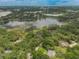 Beautiful aerial perspective showcases homes among trees, near a peaceful lake community at 120 E Greentree Ln, Lake Mary, FL 32746