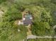 Aerial view showcases a home with a pool, mature trees, and a private setting at 120 E Greentree Ln, Lake Mary, FL 32746