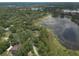 Gorgeous aerial view highlights lakefront properties embraced by dense, green tree cover at 120 E Greentree Ln, Lake Mary, FL 32746