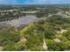 Scenic aerial view of homes nestled among lush greenery, bordering a tranquil lake community at 120 E Greentree Ln, Lake Mary, FL 32746