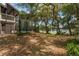 Lush backyard with a screened pool enclosure, offering privacy and scenic views of the lake at 120 E Greentree Ln, Lake Mary, FL 32746