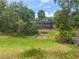 Spacious backyard featuring a fire pit and screened-in porch offers outdoor entertaining at 120 E Greentree Ln, Lake Mary, FL 32746