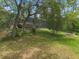 Expansive backyard with mature trees and a firepit creates a relaxing outdoor space at 120 E Greentree Ln, Lake Mary, FL 32746