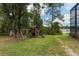 Private backyard featuring a playground, backing onto a lake for Gathering enjoyment at 120 E Greentree Ln, Lake Mary, FL 32746