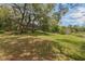 Large, scenic backyard with mature trees, firepit, and screened-in back porch at 120 E Greentree Ln, Lake Mary, FL 32746