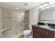 Bathroom featuring shower with seat, dark wood cabinets, granite countertop, and tile floors at 120 E Greentree Ln, Lake Mary, FL 32746