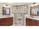 Well-lit bathroom featuring a glass shower, dual sinks, granite countertops, and updated light fixtures at 120 E Greentree Ln, Lake Mary, FL 32746