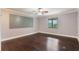 Bedroom features dark wood floors, light purple walls, crown molding, a window and a ceiling fan at 120 E Greentree Ln, Lake Mary, FL 32746