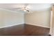 Bright bedroom with hardwood floors, ceiling fan, and neutral paint at 120 E Greentree Ln, Lake Mary, FL 32746