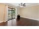Bedroom with hardwood floors and sliding glass doors to an outdoor deck at 120 E Greentree Ln, Lake Mary, FL 32746