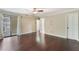 Neutral bedroom with hardwood floors, sliding glass doors, and a ceiling fan at 120 E Greentree Ln, Lake Mary, FL 32746