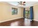Bedroom with dark wood floors, ceiling fan, window and sliding glass doors to an outdoor deck at 120 E Greentree Ln, Lake Mary, FL 32746