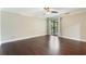 Neutral bedroom featuring hardwood floors, a ceiling fan, and sliding glass doors at 120 E Greentree Ln, Lake Mary, FL 32746