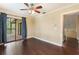 This bedroom features dark wood floors, a ceiling fan, crown molding and sliding glass doors to a deck at 120 E Greentree Ln, Lake Mary, FL 32746