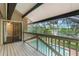 Enclosed deck featuring view of the pool and lake at 120 E Greentree Ln, Lake Mary, FL 32746