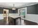 Dining room features wainscotting and French doors that open to the pool at 120 E Greentree Ln, Lake Mary, FL 32746