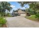 Charming home with a long driveway and a glimpse of the backyard screened pool enclosure at 120 E Greentree Ln, Lake Mary, FL 32746