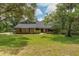 Charming brick home with a well-manicured lawn and mature trees providing shade and curb appeal at 120 E Greentree Ln, Lake Mary, FL 32746