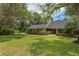 Charming two-story home features a lush lawn, mature trees and inviting walkway, creating a welcoming curb appeal at 120 E Greentree Ln, Lake Mary, FL 32746