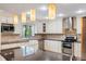 Modern kitchen with stainless steel appliances, granite countertops, and ample cabinet space at 120 E Greentree Ln, Lake Mary, FL 32746
