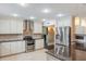 Modern kitchen with stainless steel appliances, granite countertops, and ample cabinet space at 120 E Greentree Ln, Lake Mary, FL 32746