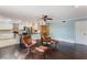 Bright living room featuring dark wood floors, ceiling fan, and an open view to the kitchen at 120 E Greentree Ln, Lake Mary, FL 32746